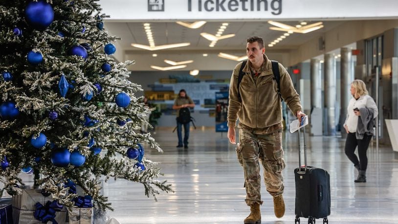 Holiday travelers move through the Dayton International Airport Tuesday, Dec. 12, 2023. AAA projects 4.7 million Ohioans and more than 389,000 Dayton area residents will travel over the 10-day year-end holiday travel period of Dec. 23, 2023 to Jan. 1, 2024.  JIM NOELKER/STAFF
