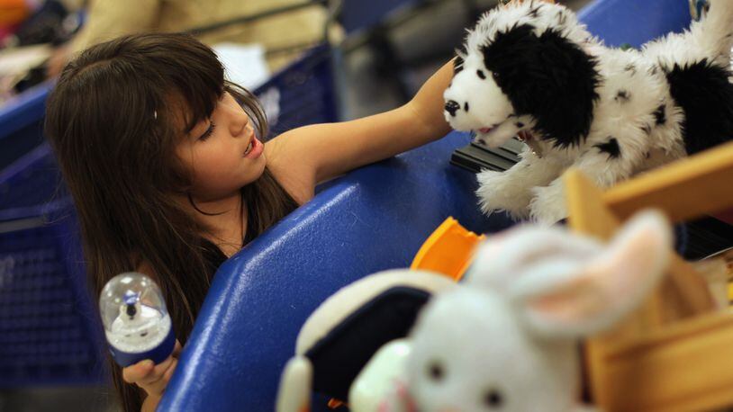 A girl chooses toys at a Goodwill thrift store in Denver. An anonymous donor bought the toy section of a Fort Collins, Colorado, Goodwill for kids in need (not pictured).