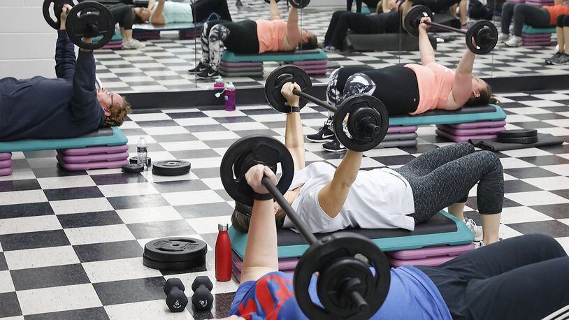 Weight training decreases blood pressure, lowers cholesterol and provides other health benefits. Bill Lackey/Staff