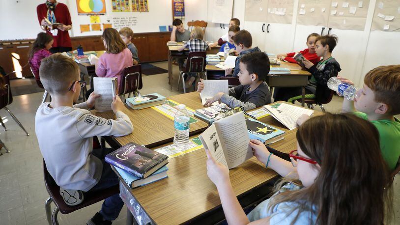 Students at Reid School go over a reading assignment in class Wednesday, Nov. 29, 2017. Bill Lackey/Staff