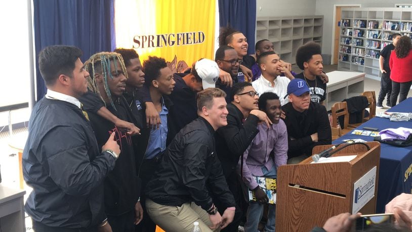 Springfield High School football players pose for a photo during a signing day ceremony at the school on Thursday. MARCUS HARTMAN/ STAFF