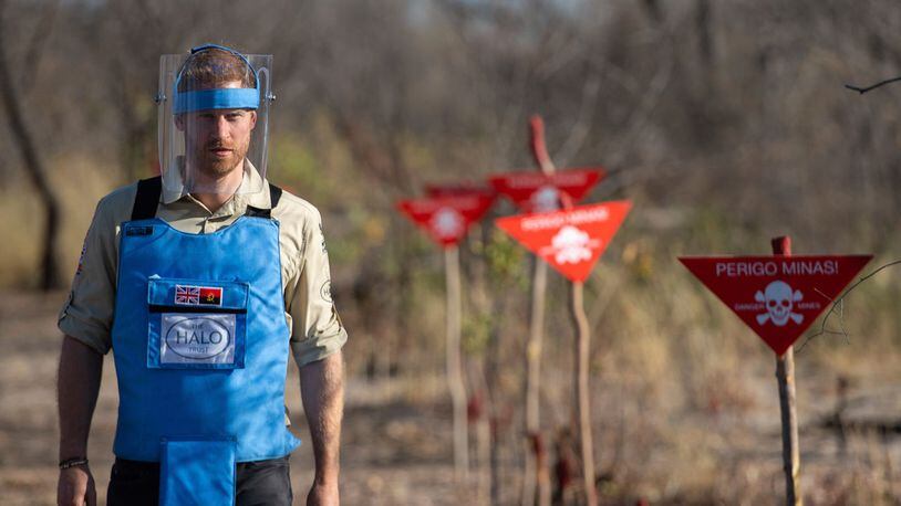 Britain's Prince Harry walks through a minefield in Dirico, Angola Friday Sept. 27, 2019, during a visit to see the work of landmine clearance charity the Halo Trust, on day five of the royal tour of Africa.