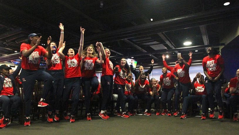 Dayton players react to earning a berth in the NCAA women’s tournament at UD Arena on Monday, March 12, 2018. David Jablonski/Staff