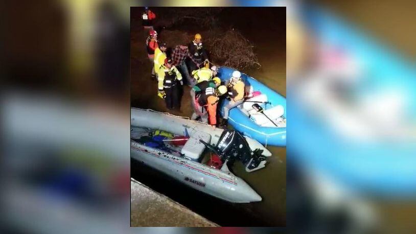 Emergency responders help rescue three kayakers  trapped on a fast-running river in Upson County in central Georgia.