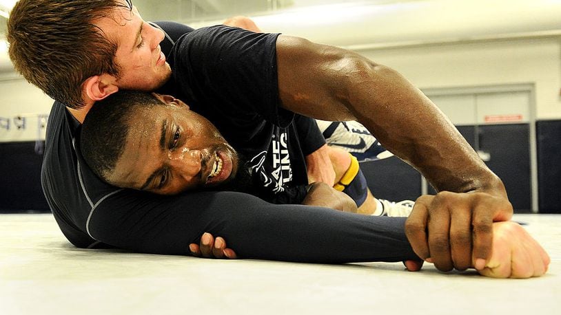 STATE COLLEGE, PA - NOVEMBER 07: UFC light heavyweight fighter Phil Davis works out with Penn State 165-weight senior wrestler David Taylor during the ‘20 days to UFC 167’ media tour at the Lorenzo Wrestling Complex on the campus of Penn State University on November 7, 2013 in State College, Pennsylvania. (Photo by Patrick Smith/Getty Images)