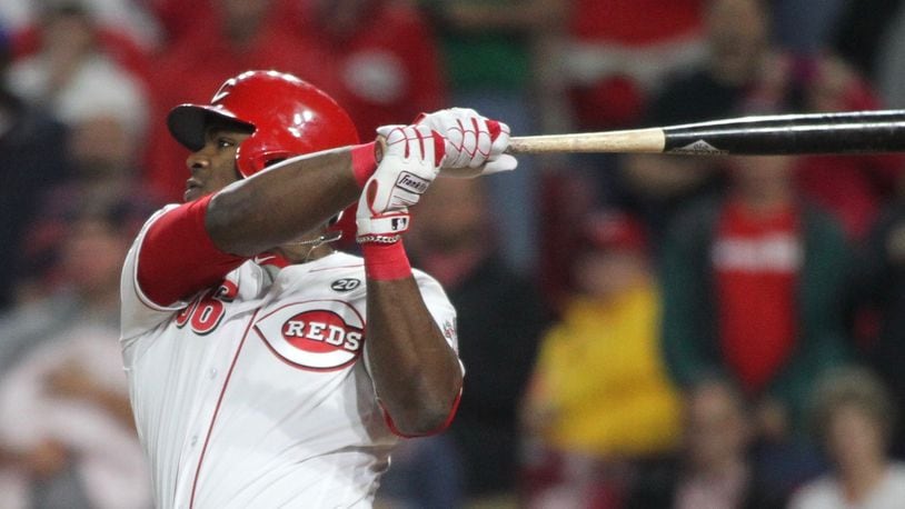 The Reds' Yasiel Puig singles in the 10th to drive in the winning run against the Cubs on Wednesday, May 15, 2019, at Great American Ball Park in Cincinnati.