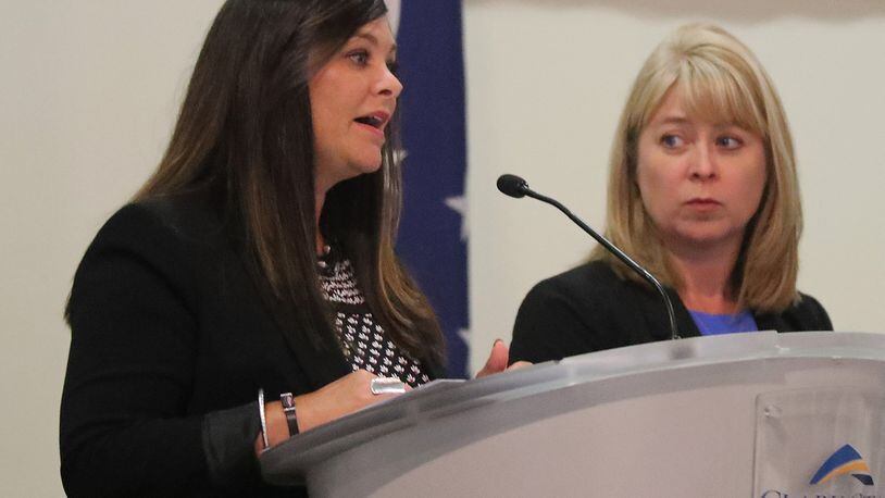 Amy Donahoe, director of Workforce Development for the Chamber of Greater Springfield, left, and Toni Overholser, director of the Clark State Foundation, speak at the Springfield Rotary Club meeting Monday. BILL LACKEY/STAFF