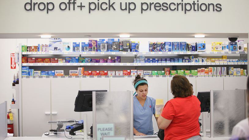 Pharmacy technician Angelina Lombardo helps a customer at a Walgreens pharmacy on September 19, 2013 in Wheeling, Illinois. A December 2016 report says new legislation introduced by Sen. Elizabeth Warren, D-Massachusetts, and Sen. Chuck Grassley, R-Iowa, may allow customers to buy hearing aids over the counter (Photo by Scott Olson/Getty Images)