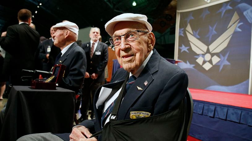 In this April 18, 2015, file photo, two members of the Doolittle Tokyo Raiders, retired U.S. Air Force Lt. Col. Richard "Dick" Cole, seated front, and retired Staff Sgt. David Thatcher, seated left, pose for photos after the presentation of a Congressional Gold Medal honoring the Doolittle Raiders at the National Museum of the U.S. Air Force at Wright-Patterson Air Force Base in Dayton, Ohio. Retired Lt. Col. Richard "Dick" Cole, the last of the 80 Doolittle Raiders who carried out the daring U.S. attack on Japan during World War II, died Tuesday at a military hospital in Texas.