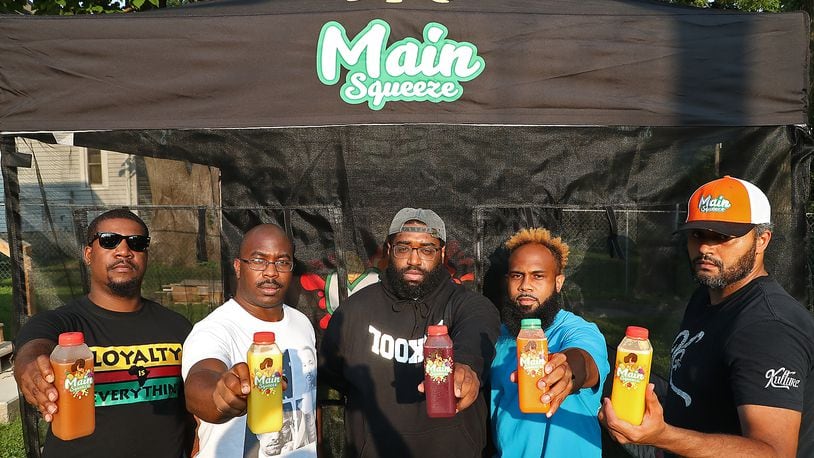 The owners of the Main Squeeze juice bar stand with some of their products, from left, Jafar Jones, Melvin Hardnick Jr, Earl Taylor, Marcus Clark and Craig Williams. BILL LACKEY/STAFF