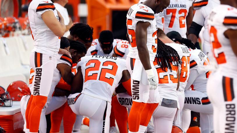 Members of the Cleveland Browns kneel during the national anthem before an NFL preseason football game against the New York Giants on Aug. 21 in Cleveland. (AP Photo/Ron Schwane)