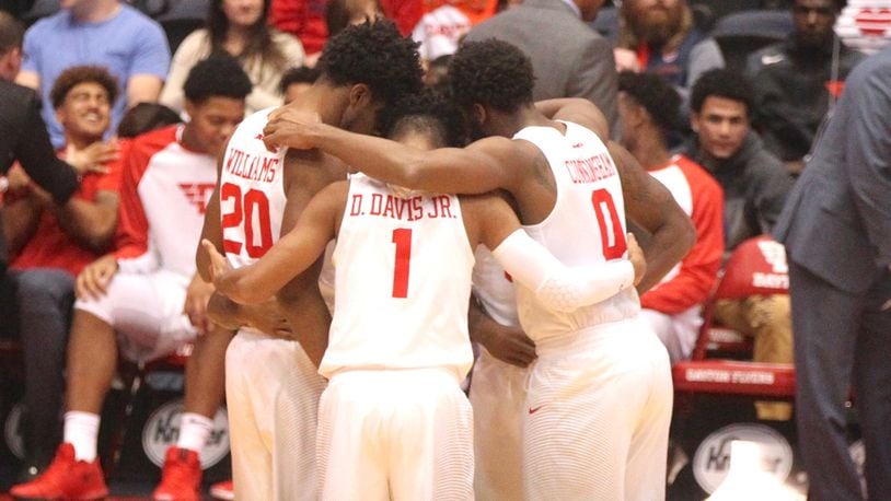 The Dayton Flyers huddle before a game against Ball State on Friday, Nov. 10, 2017, at UD Arena.