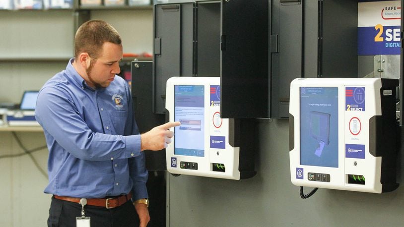 Nick Latessa, an elections operation supervisor at the Montgomery County Board of Elections, demonstrates voting technology on Wednesday during a visit by Ohio Secretary of State Frank LaRose. CHRIS STEWART / STAFF