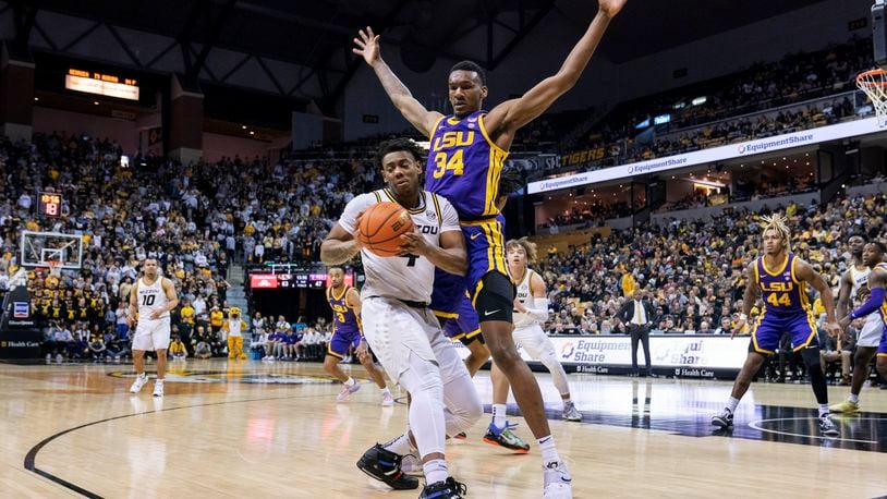 Missouri's DeAndre Gholston, turns away from LSU's Shawn Phillips, right, during the second half of an NCAA college basketball game Wednesday, Feb. 1, 2023, in Columbia, Mo. Missouri won 87-77.(AP Photo/L.G. Patterson)