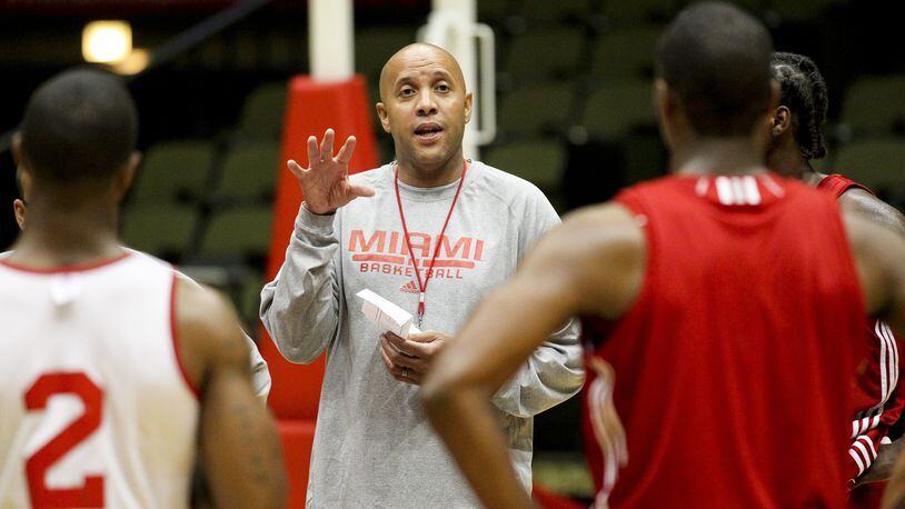 Miami University head basketball coach John Cooper talks with his squad during a summer practice session Tuesday at Millett Hall in Oxford. Staff photo by Nick Daggy