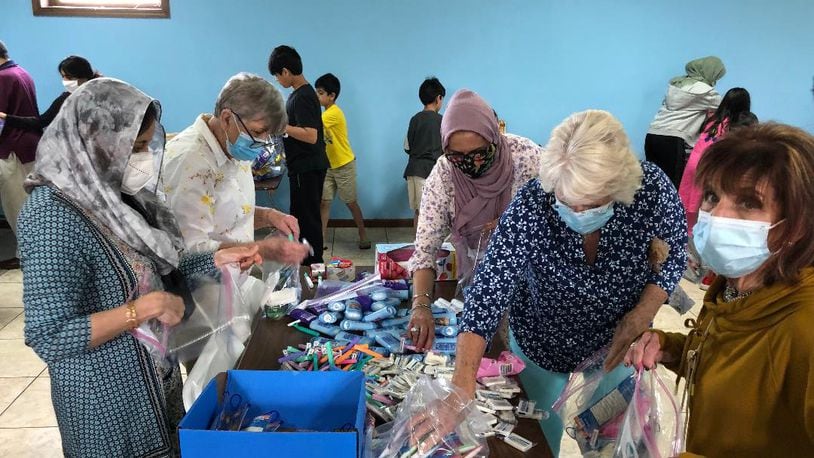 Members of the Christian and Muslim faiths teamed up to pack 400 bags of food and hygiene items at theMasjid Al-Madina Mosque on Sunday to support the Springfield Soup Kitchen.