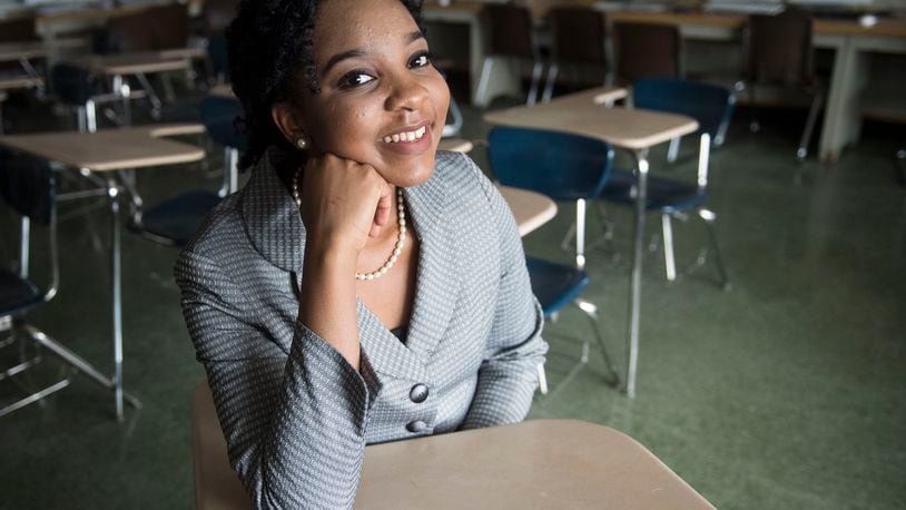 Elmont Memorial High School valedictorian Augusta Uwamanzu-Nna poses for a photo in an empty classroom in Elmont, N.Y. Uwamanzu-Nna has won acceptance to all 12 schools she applied for including all eight Ivy League universities. It’s the second time in as many years a student at the suburban New York high school has been accepted at all eight Ivy League universities.