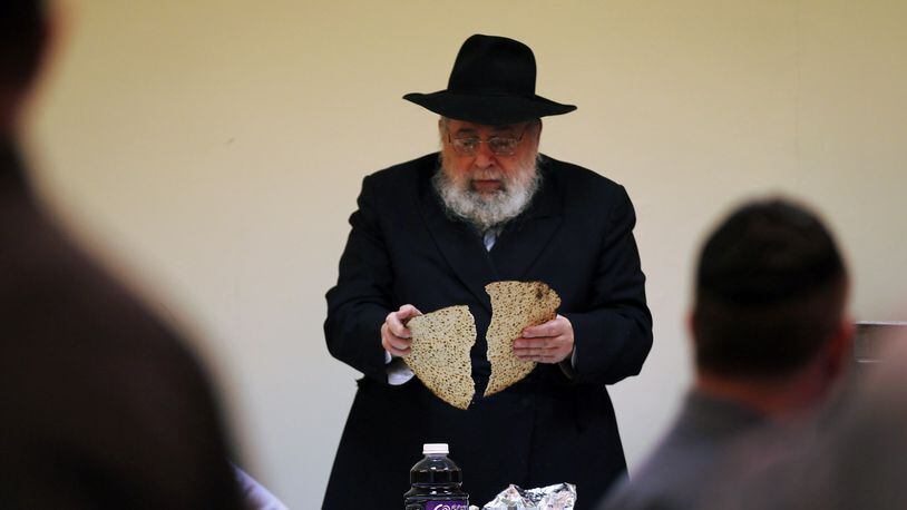MIAMI BEACH, FL - MARCH 25: Rabbi Efraim Katz breaks a piece of matzo as he leads a community Passover Seder at Beth Israel synagogue on March 25, 2013 in Miami Beach, Florida. The community Passover Seder that served around 150 people has been held for the past 30 years and is welcome to anyone in the community that wants to commemorate the emancipation of the Israelites from slavery in ancient Egypt. (Photo by Joe Raedle/Getty Images)