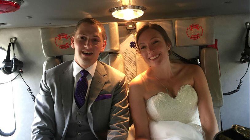 Justin Stone and Maria Leonardi, of New York City, hitched a ride to their wedding reception with Avon, Connecticut, firefighters Saturday, June 10, 2017, after their wedding bus caught on fire.