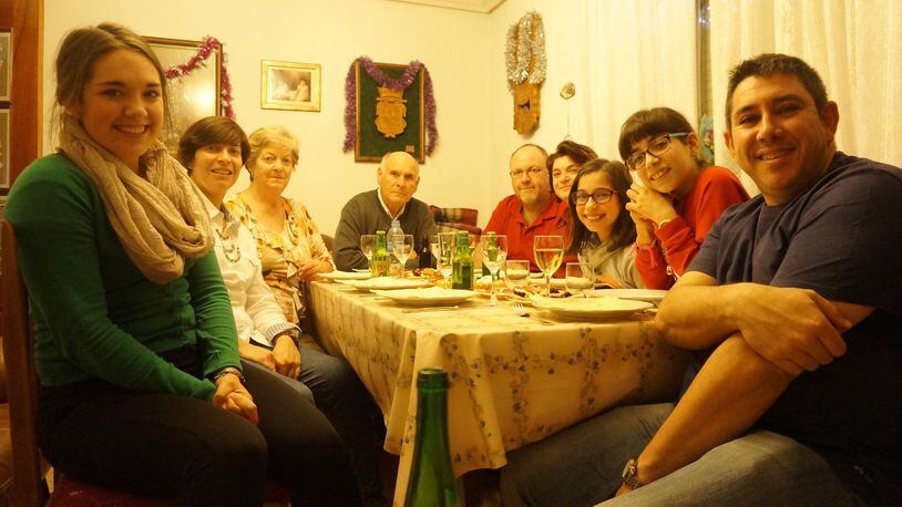 Rachel Leake (left) in Spain with some of her host mom’s extended family, ready for Christmas dinner last year. CONTRIBUTED
