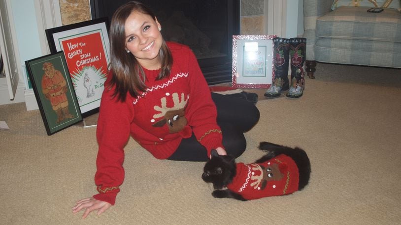 Karin Spicer's daughter Jordan and Jordan's cat Wednesday all decked out in their Christmas sweaters. CONTRIBUTED