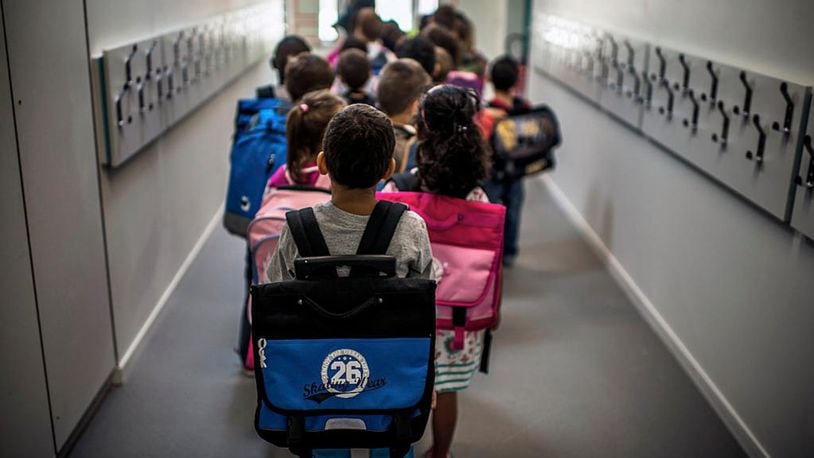Children wait in line to go to class on the first day of school following the summer holidays. A new study finds kids with ADHD may have smaller brains.