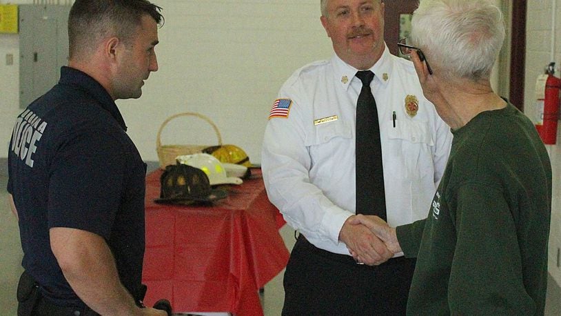 Urbana City employees and community members congratulates retired Fire Chief Mark Keller after 26 years of service. JEFF GUERINI/STAFF