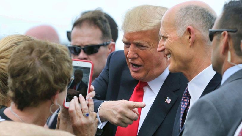 Accompanied by Florida governor Rick Scott, who is also running for the U.S. Senate, President Trump is welcomed at Orlando International Airport, Monday, Oct. 8, 2018. Trump delivered remarks at the International Association of Chiefs of Police, at the Orange County Convention Center, in Orlando, Fla.