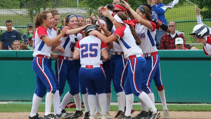 Northwestern sophomore Bry White gets congratulated by her teammates at home after hitting a solo home run in the fifth inning of the Warriors’ 7-0 win against Badin in the Division III regional semifinal on Wednesday at Wright State University. GREG BILLING / CONTRIBUTED