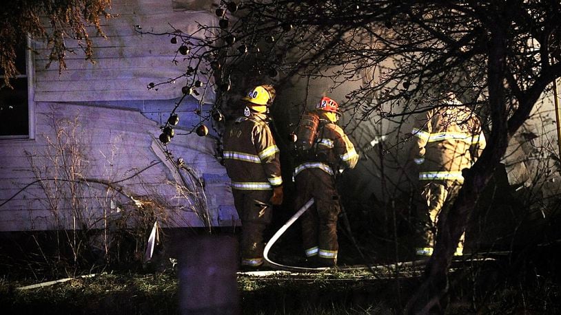 One person is dead after a car crashed into a house and both caught fire Wednesday evening, Dec. 8, 2021, in the 9900 block of state Route 235 in Champaign County on the border with Logan County. MARSHALL GORBY/STAFF