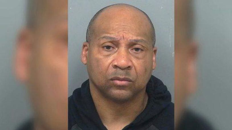 Ernest Earls was arrested Friday after his neighbor called authorities to report what he had seen on the other side of his fence in Gwinnett County, Georgia.