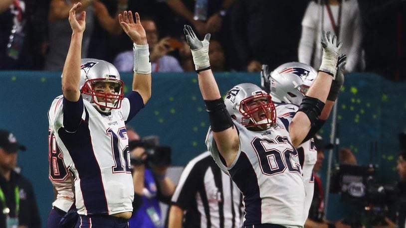 HOUSTON, TX - FEBRUARY 05: Tom Brady #12 and Joe Thuney #62 of the New England Patriots celebrate a 34-28 overtime win against the Atlanta Falcons during Super Bowl 51 at NRG Stadium on February 5, 2017 in Houston, Texas. (Photo by Al Bello/Getty Images)