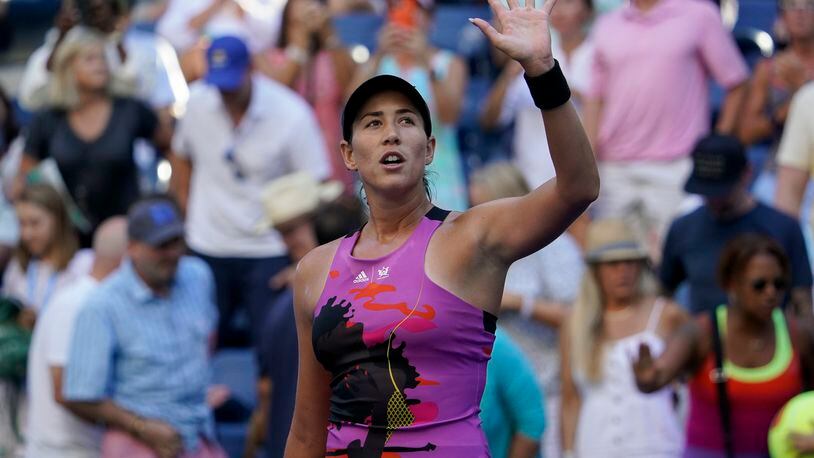 FILE - Garbiñe Muguruza of Spain waves to fans after defeating Linda Fruhvirtova, of the Czech Republic, during the second round of the U.S. Open tennis championships, Thursday, Sept. 1, 2022, in New York. Former top-ranked Garbiñe Muguruza has announced that she is retiring from professional tennis at age 30. (AP Photo/Seth Wenig, File)