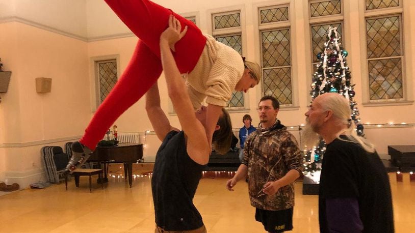 Kaitlin Musik gets a lift from Nethaniel Tackett while Ray Jones adds support and show director D. Scot Davidge surveys the action during a rehearsal of the Ohio Performing Arts Institute's 32nd annual production of "The Nutcracker." Photo by Brett Turner