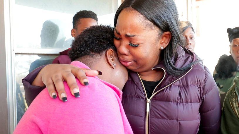Bernice Parks, left, is consoled by Jasmine Wells, the godmother of Parks' daughter Sandra, who was shot to death Monday in Milwaukee.
