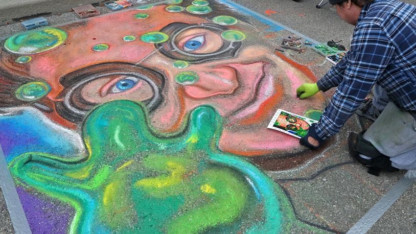Paul Arnold works on his chalk artwork during the National Trail Parks and Recreation District's annual ChalkFest Saturday, Oct. 1, 2022 at National Road Commons Park. BILL LACKEY/STAFF