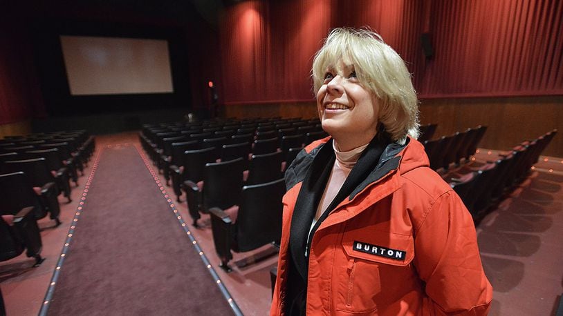 Sandi Arnold, executive director of the Champaign County Chamber of Commerce and Visitors Bureau, looks over the inside of the old Urbana theater Tuesday. The Urbana United Methodist Church plans to purchase the theater, add a cafe and a new performing arts center for the community. Bill Lackey/Staff