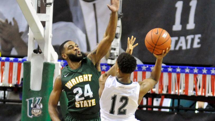 Wright State junior guard Mark Alstork alters the shot of Cleveland State freshman guard Kasheem Thomas Saturday during the Raiders’ 74-68 double-overtime win at the Wolstein Center. JAY MORRISON/STAFF PHOTO