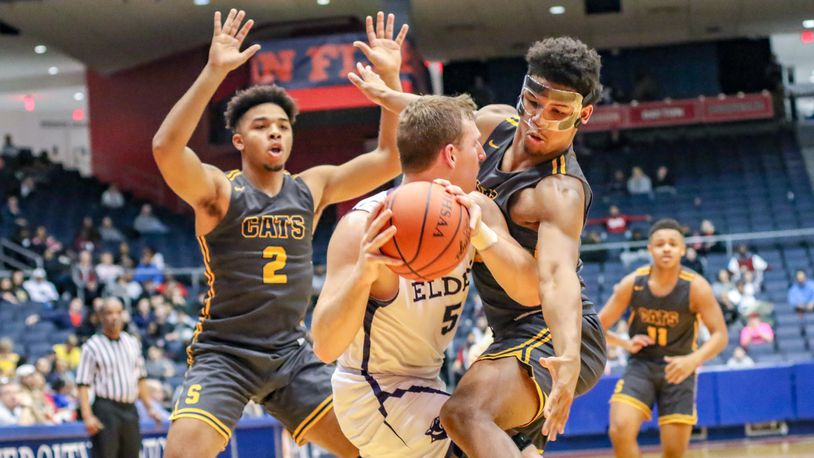 Springfield’s Jalan Minney (right) and Jordan Howard (2) trap Elder’s Michael Bittner during a Division I district final game on Saturday night at the University of Dayton Arena. The Wildcats won 55-35. CONTRIBUTED PHOTO BY MICHAEL COOPER