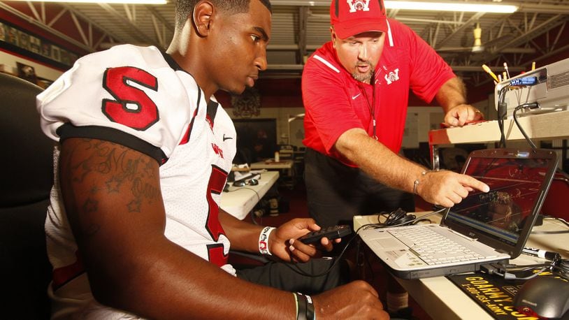 Braxton Miller, the Wayne High School quarterback who has committed to play his college football at Ohio State, is one of the most outrageous athletic talents to come through the area in recent memory. Some services have ranked him the No. 1 overall recruit in the country. He looks at game film with offensive coordinator Brian Blevins, who is on Wayne’s staff for the first year after resigning as Fairmont High School’s head coach. Staff photo by Jim Witmer