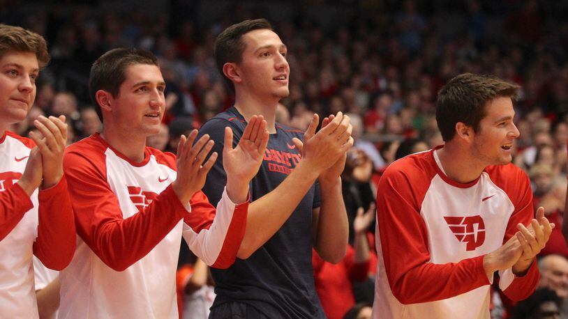 Dayton players (left to right) Dalton Stewart, Jack Westerfield, Ryan Mikesell and Joey Gruden watch a game against Ball State at UD Arena on Nov. 10, 2017.