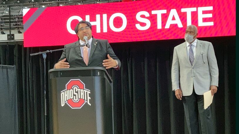 Sen. Niraj Antani, a suburban Dayton Republican, speaks about a bill that would allow athletes at Ohio colleges to earn compensation through endorsements and sponsorship deals based on their names, images and likenesses on Monday, May 24, 2021, in Columbus, Ohio. Looking on at right is Ohio State University Athletics Director Gene Smith.  (AP Photo/Andrew Welsh-Huggins)