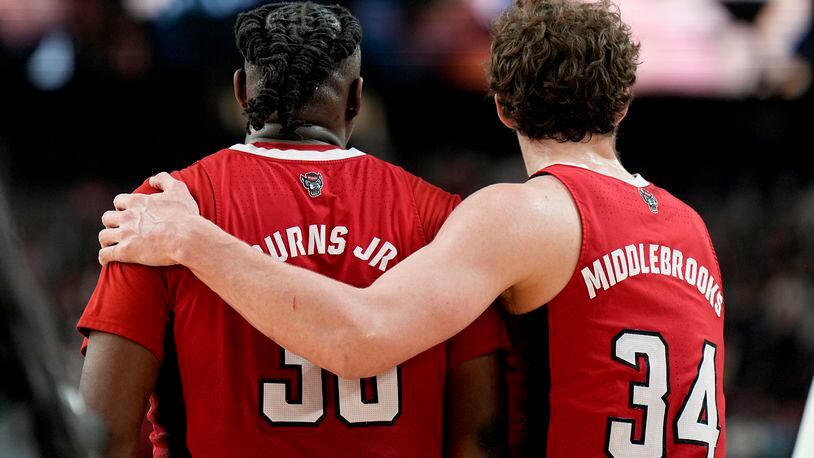 NC State forward Ben Middlebrooks (34) leaves the court with forward DJ Burns Jr. after the NCAA college basketball game against Purdue at the Final Four, Saturday, April 6, 2024, in Glendale, Ariz. (AP Photo/Brynn Anderson )