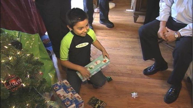 Scott Heavner received gifts from sheriff's deputies as Christmas arrived early for the 8-year-old boy.