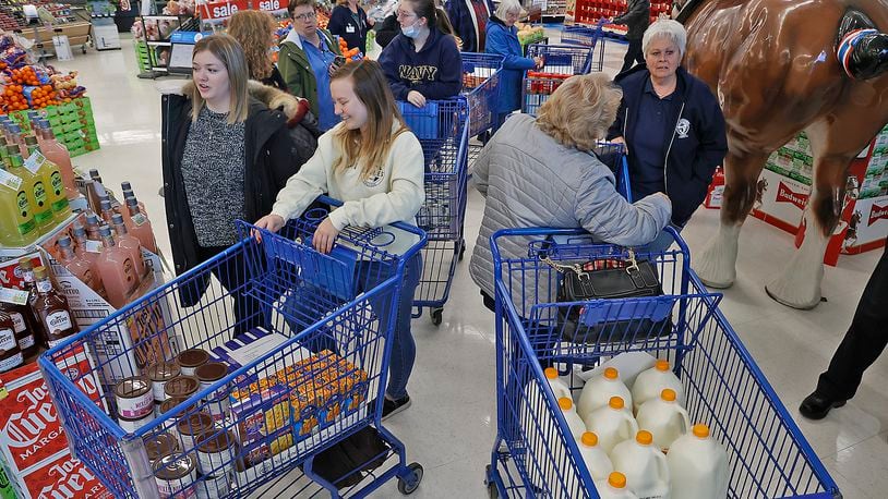 Operation Thanksgiving volunteers gather after collecting food at Meijer Tuesday, Nov. 22, 2022. BILL LACKEY/STAFF