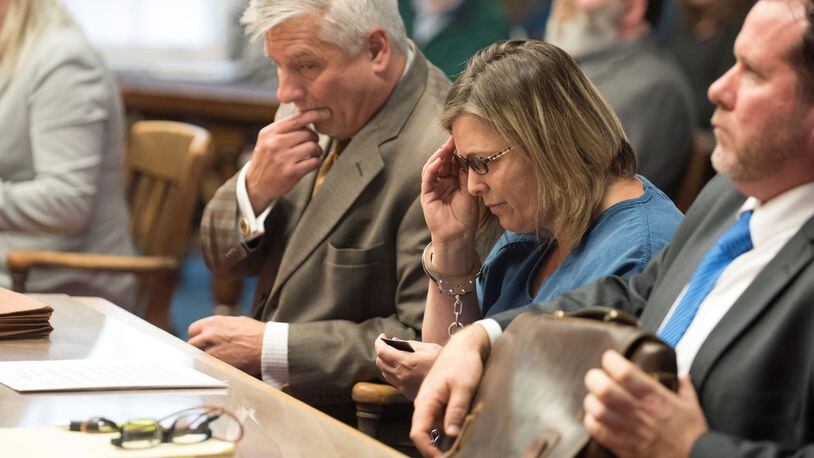 Angela Wagner, 48, adjusts her reading glasses as her attorney Robert Krapenc, left, looks at a copy of the indictment charging Wagner in the 2016 Pike County murders. ROBERT MCGRAW / CHILLICOTHE GAZETTE / POOL PHOTO