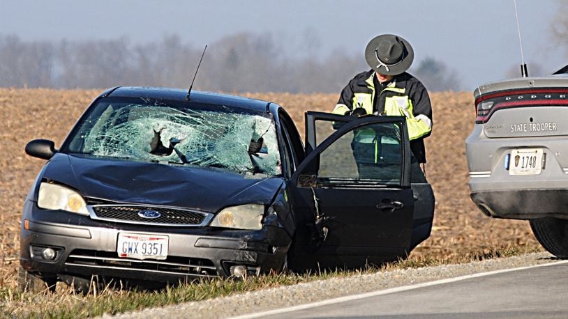 The Ohio State Highway Patrol investigate after two pedestrians were struck, one fatally, on Old Springfield Road in Clark County Tuesday morning. Marshall Gorby/Staff