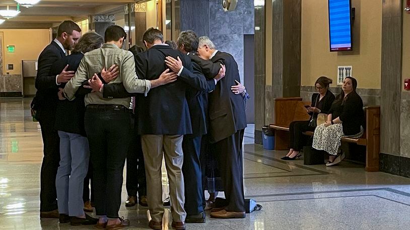 Covenant School parents and their attorneys huddle in prayer outside a courtroom before a hearing to decide whether documents and journals of a Nashville school shooter can be released to the public Wednesday, April 17, 2024, in Nashville, Tenn. A Tennessee judge will soon decide whether the journals of a Nashville school shooter can be released to the public, after nearly a year of legal wrangling over who can participate in the case. (AP Photo/Travis Loller)