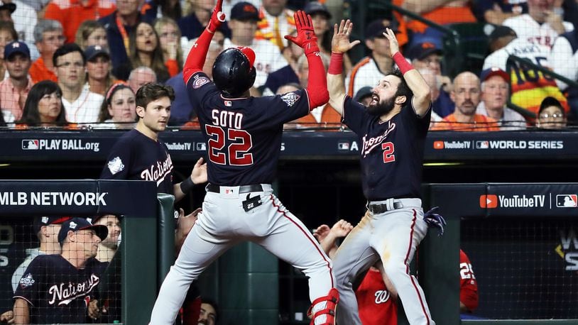 HOUSTON, TEXAS - OCTOBER 29:  Juan Soto #22 of the Washington Nationals is congratulated by his teammate Adam Eaton #2 after hitting a solo home run against the Houston Astros during the fifth inning in Game Six of the 2019 World Series at Minute Maid Park on October 29, 2019 in Houston, Texas. (Photo by Elsa/Getty Images)