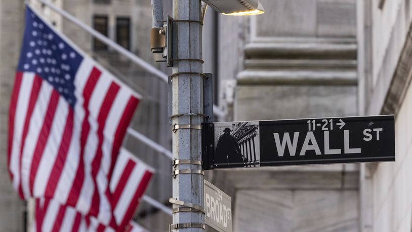 FILE - Signs at the intersection of Wall St. and Broad St. are shown outside the New York Stock Exchange, March. 21, 2024, in New York. (AP Photo/Yuki Iwamura, FILE)